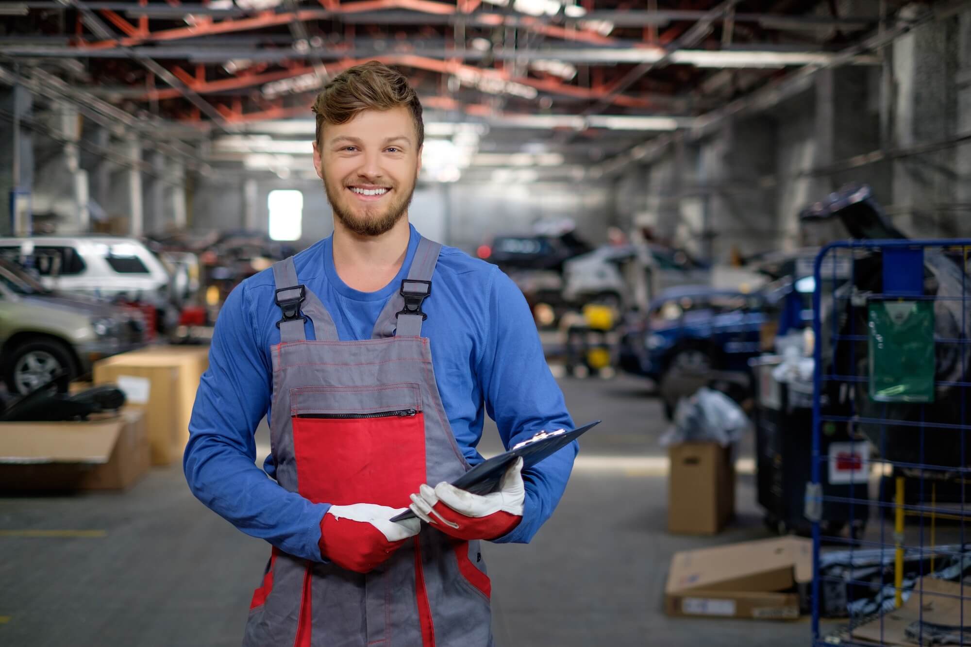 car service technician holding a clipboard