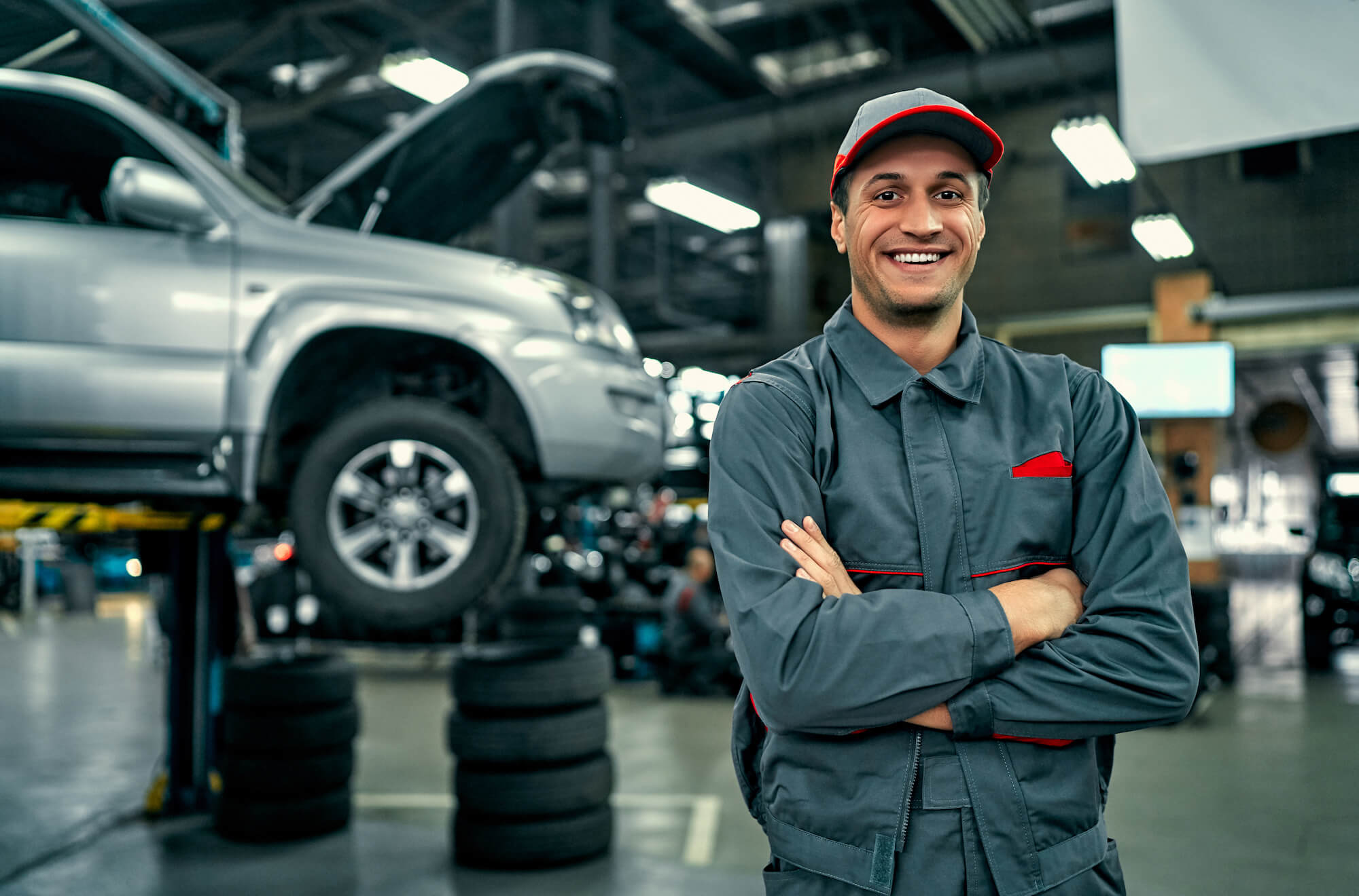 car service technician smiling with arms folded